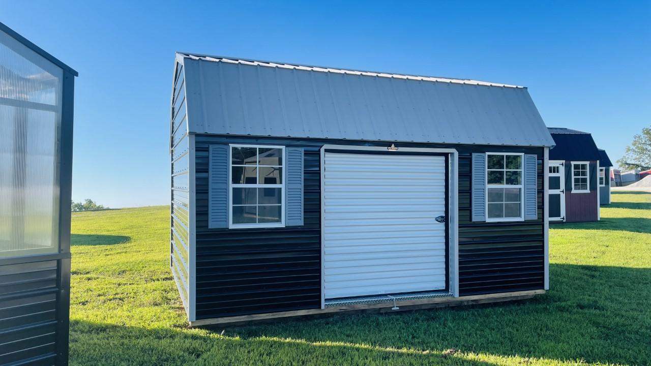 Exterior of lofted barn shed with windows and garage door